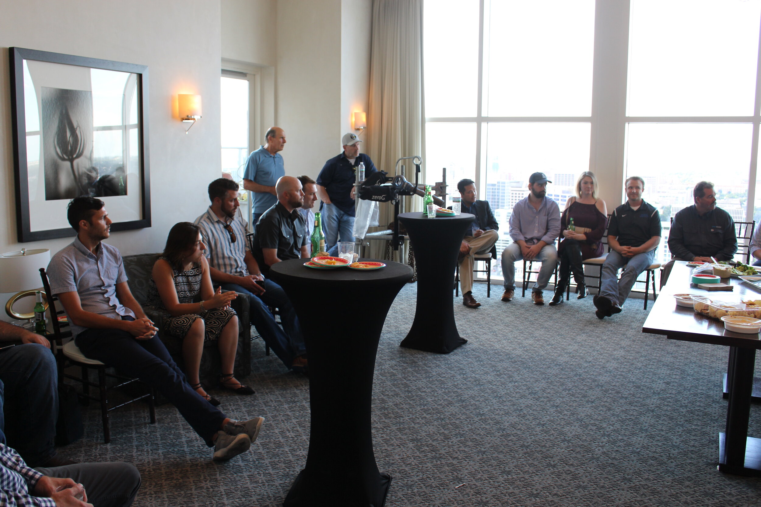 A group gathered for a conversation in a bright hotel meeting room, from the original Murdoch Group website